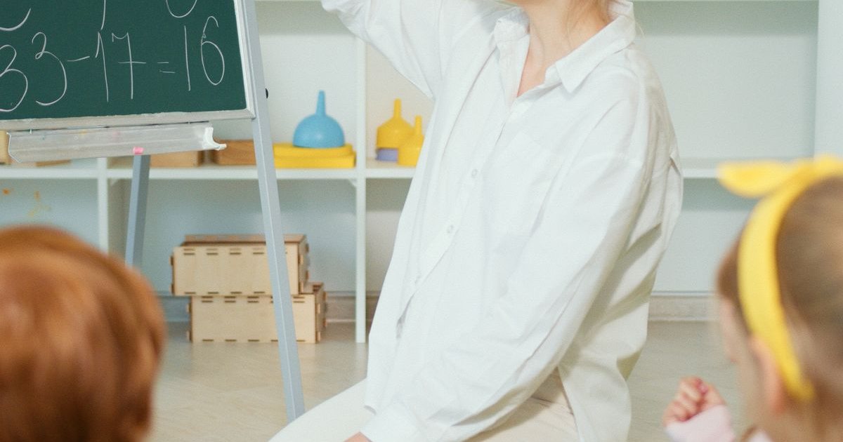 A teacher working with young students in a classroom, the starting point of a path toward district leadership