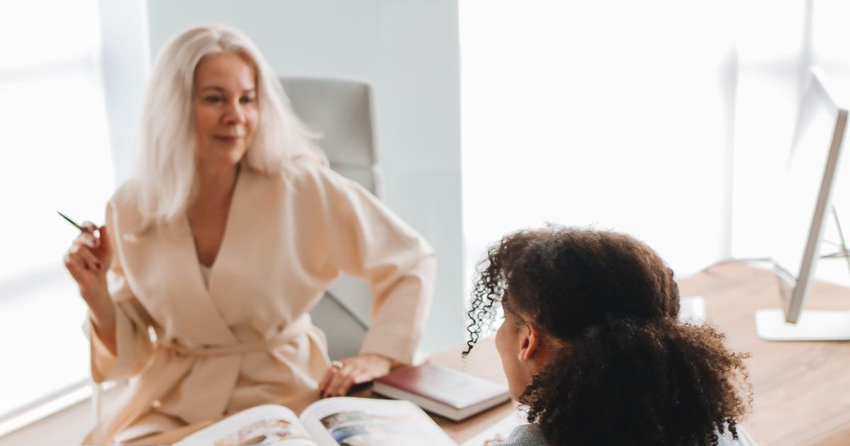 A school counselor working one to one with a student at a table