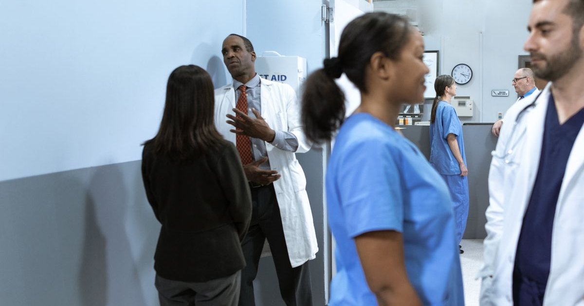 Clinical staff conferring on a hospital ward