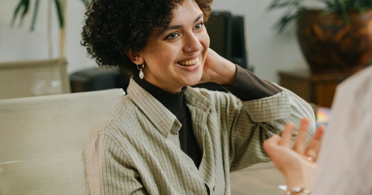 Two people in conversation in a warm, informal counseling setting