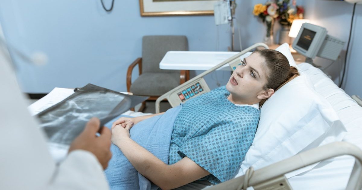 A nurse practitioner attending to a patient at the bedside