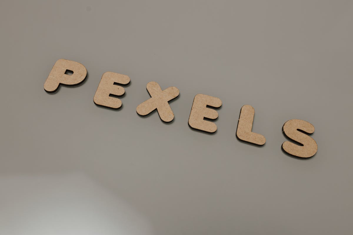 Wooden alphabet letters arranged on a neutral background