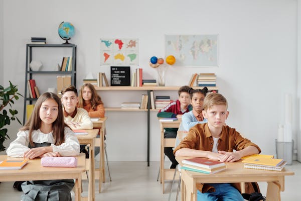 Students working through educational activities in a classroom setting