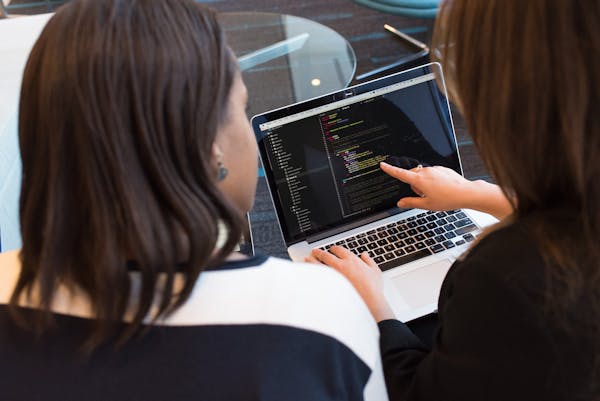 Programmer writing code at a desk
